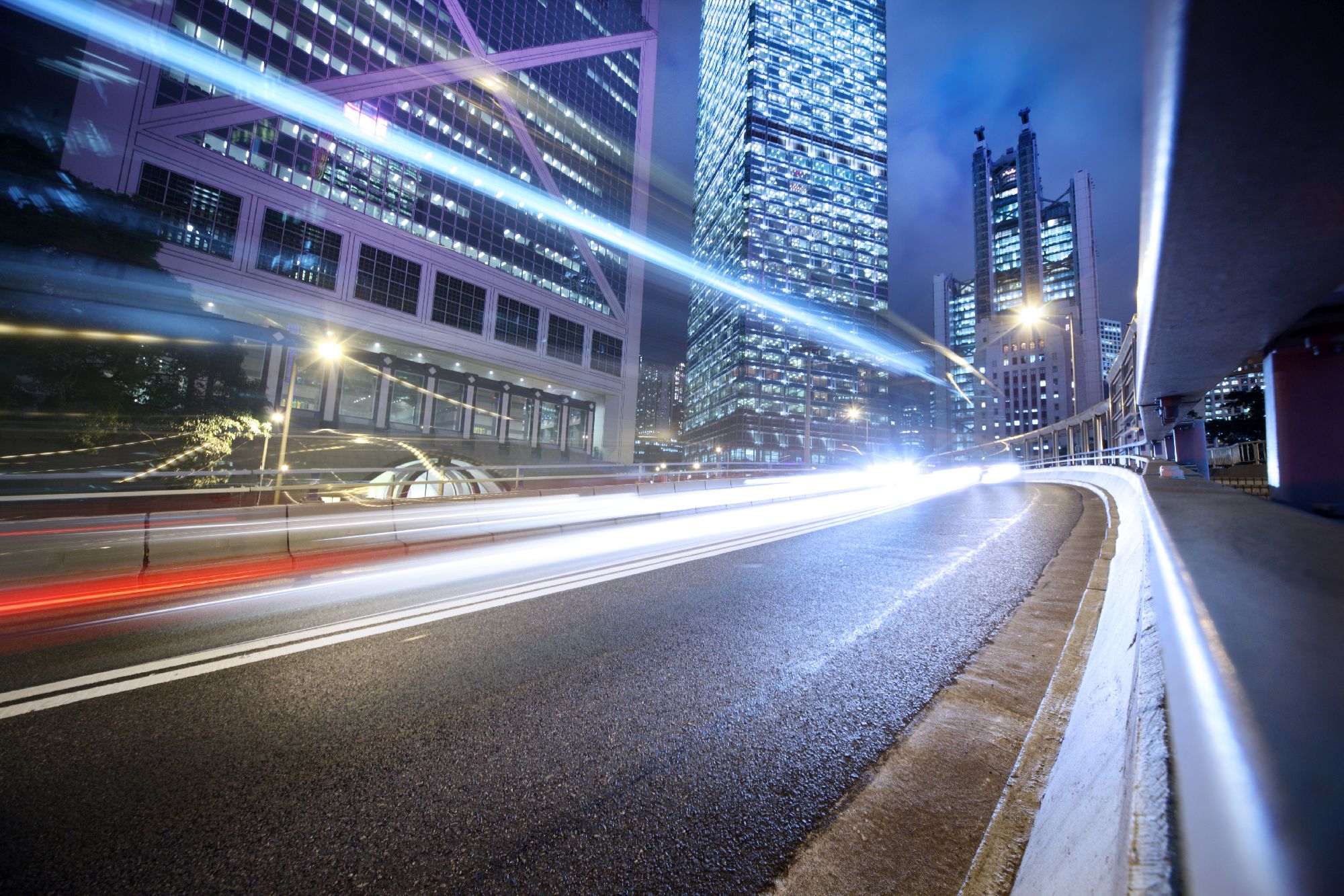Long exposure lights of a moving cars with modern city in the background - Change Management