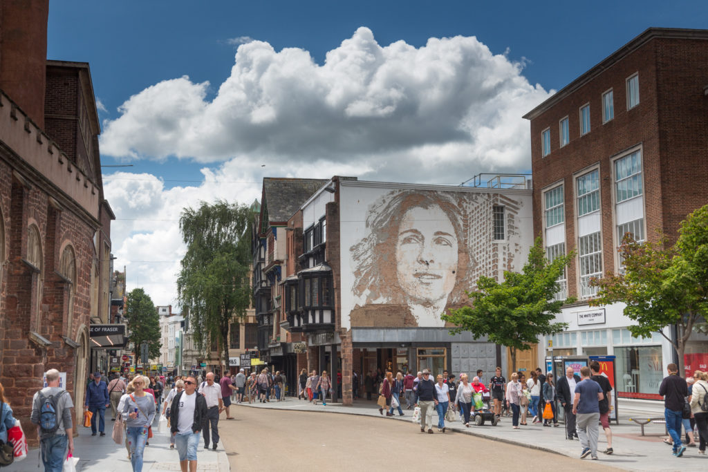 Urban Outfitters commission of a lady's head and shoulders on Exeter's High Street by Alexandre Farto (Vhils)