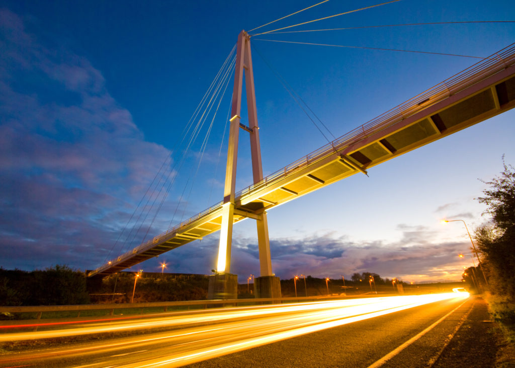 A night view of Baker Bridge in Exeter, Devon with long exposure car lights on the road underneath