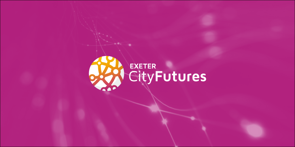 Exeter City Futures logo on pink background with ECF branded spangles in background