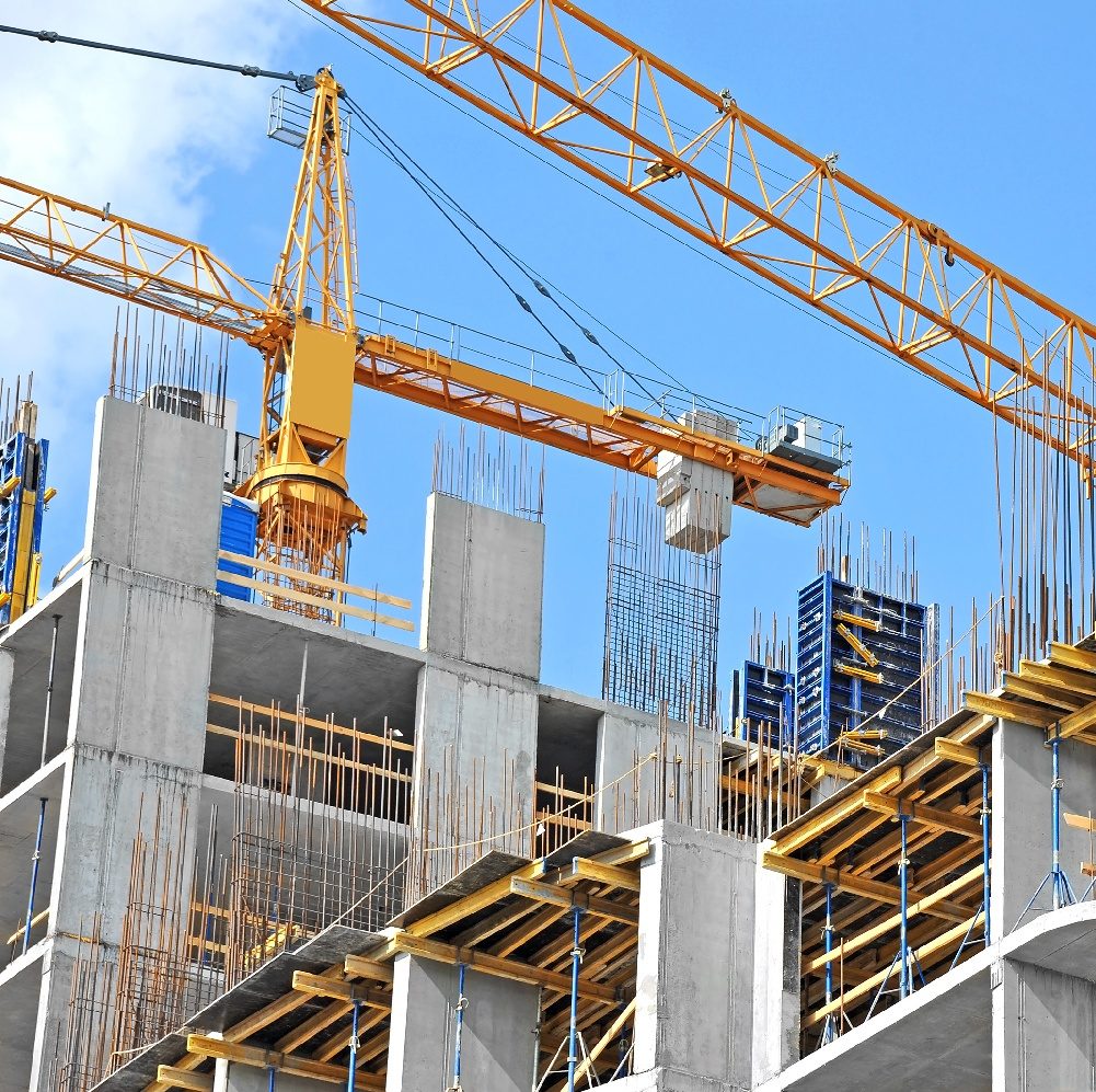 A view of the top of a building construction site with cranes